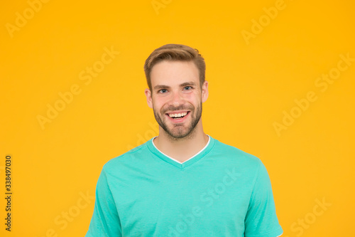 happy man with bristle on face. healthy teeth concept. guy with positive smile. male beauty. handsome man has stylish haircut. shaving and grooming at barbershop. hairdresser salon service