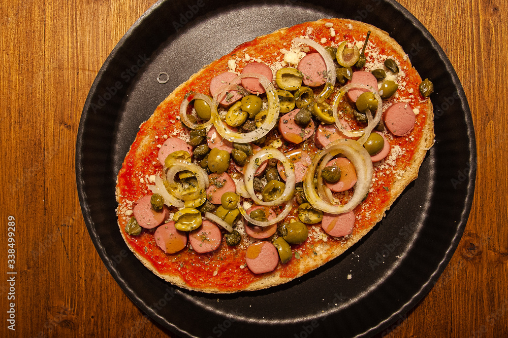 Top view of bruschetta with hot dog, onion and olives. Concept: restaurant, snack, work in the kitchen Top view of bruschetta with hot dog, onion and olives. Concept: restaurant, snack, work in the kitchen