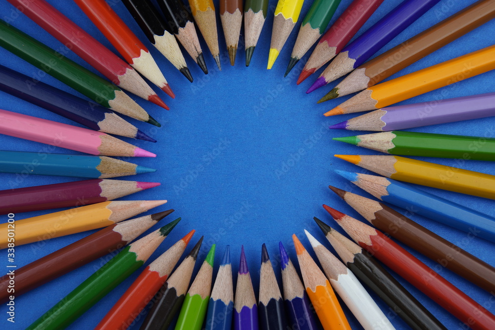 multicolored pencils on a colored background