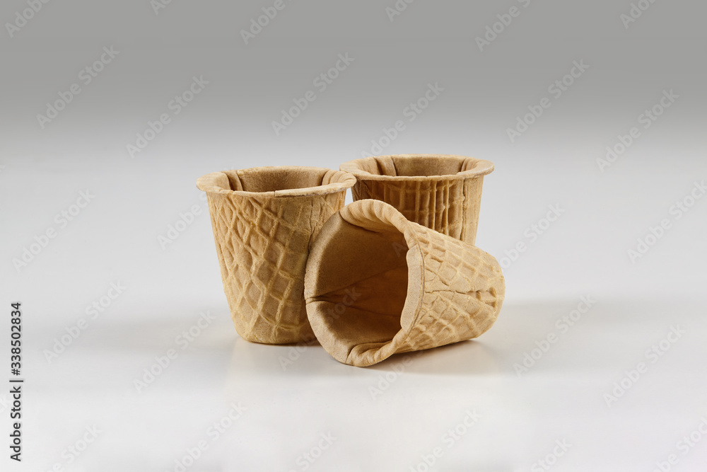 Three empty wafer cups for ice cream isolated on white background. Concept of food, treats. Mockup, template for your advertising and design. Close up Three empty wafer cups for ice cream isolated on white background. Concept of food, treats. Mockup, template for your advertising and design. Close up
