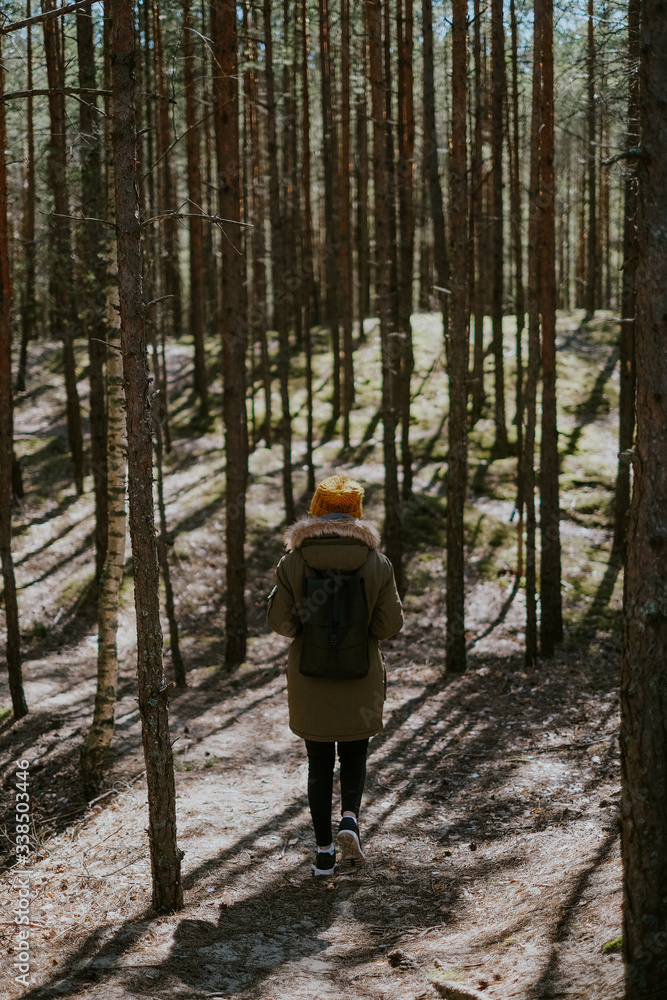 Girl walking in Latvian forest