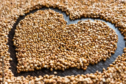 close shot of heart made of brown buckwheat pictured from the right side