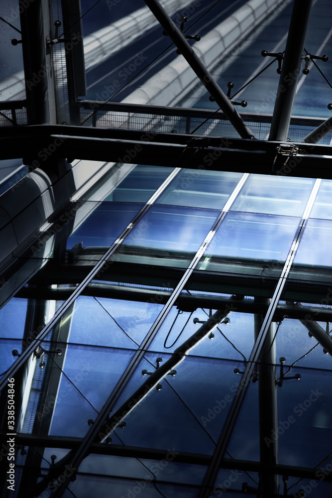 Perspective shot of glass and steel frame and canopy on a city building