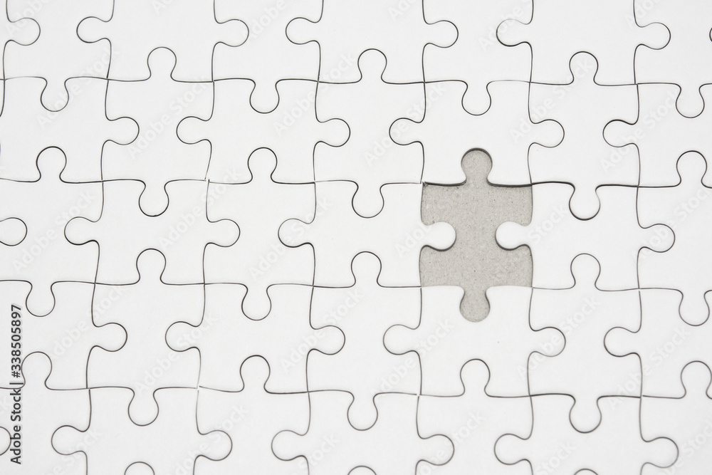 White jigsaw puzzle pattern background. placing last piece of jigsaw puzzle White jigsaw puzzle pattern background. placing last piece of jigsaw puzzle