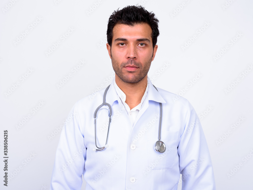 Handsome Turkish man doctor against white background Handsome Turkish man doctor against white background