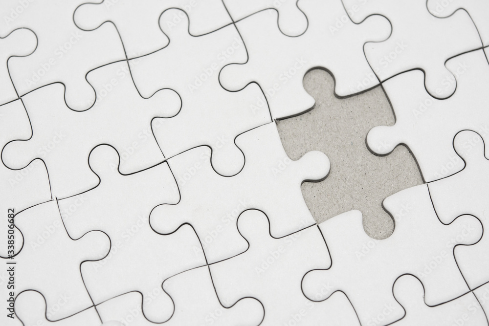 White jigsaw puzzle pattern background. placing last piece of jigsaw puzzle White jigsaw puzzle pattern background. placing last piece of jigsaw puzzle