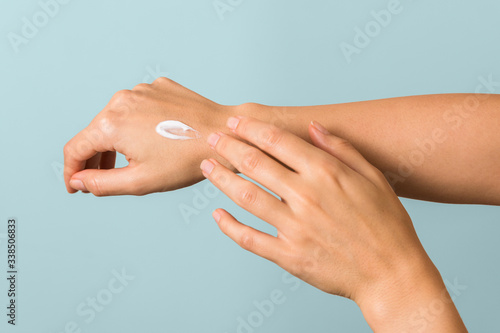 healthy hands of a young woman applying the moisture cream. skincare concept beauty photoshoot