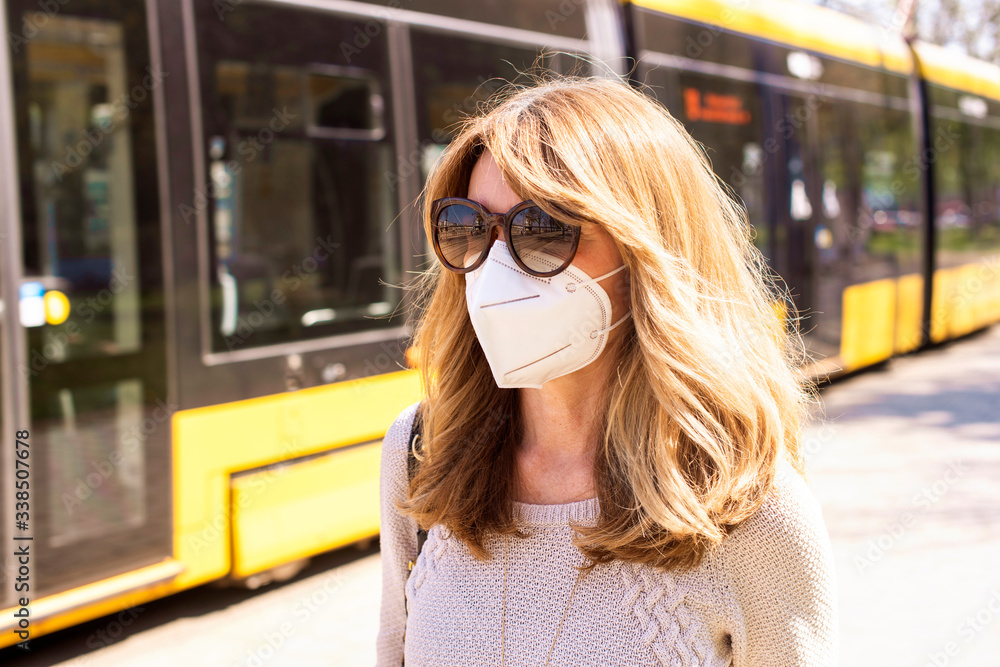 Close-up of mature woman protecting herself with face mask during coronavirus outbreak