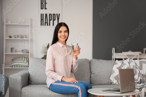 Beautiful young woman drink...