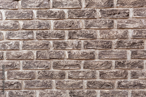 Handmade bricks on a white background. A rock. Construction. The wall is made of bricks.
