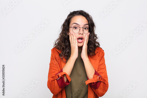 Bild auf Leinwand young pretty woman feeling shocked and scared, looking terrified with open mouth
