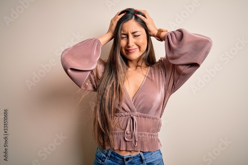 Tableau sur toile Young beautiful brunette elegant woman with long hair standing over isolated background suffering from headache desperate and stressed because pain and migraine