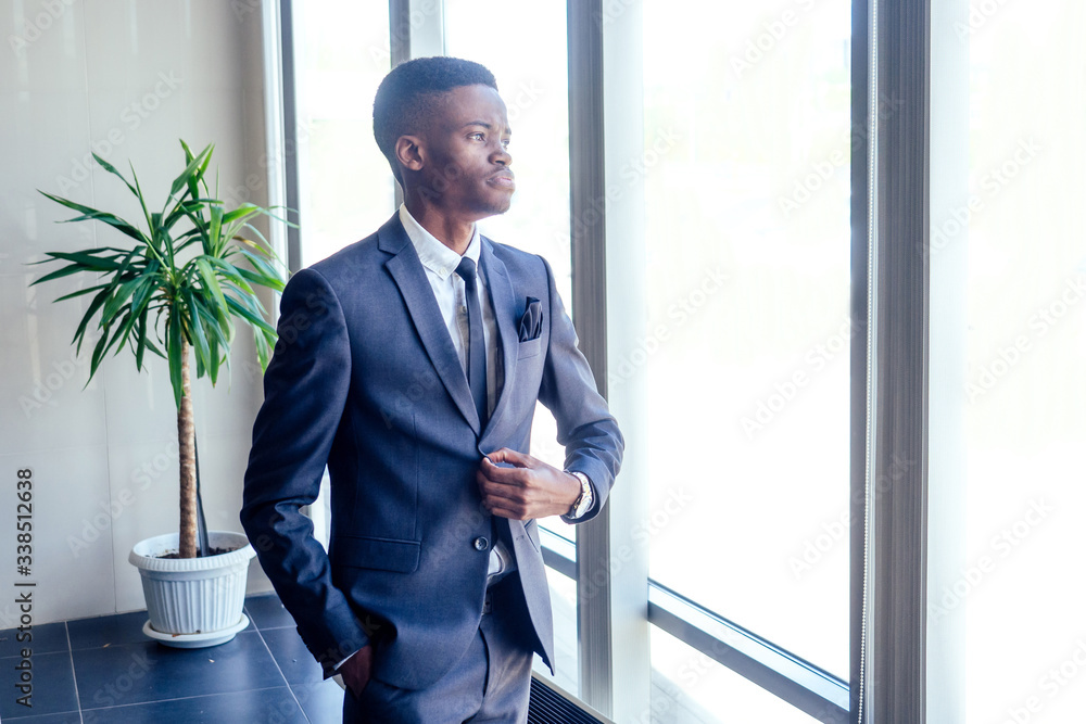 Handsome cheerful african american in a modern office with a panoramic window Handsome cheerful african american in a modern office with a panoramic window