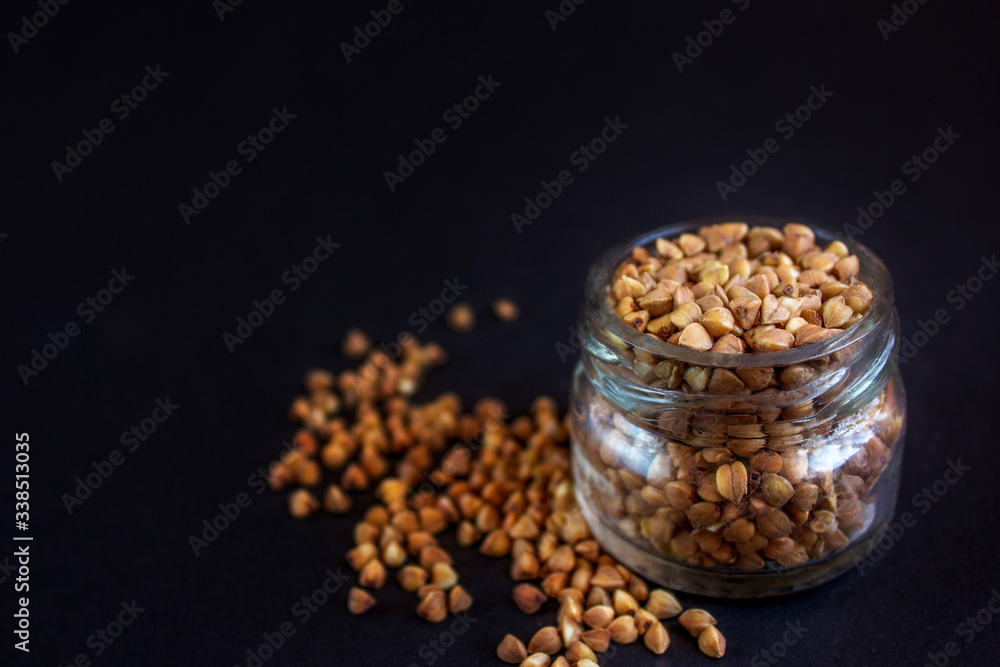 groats, buckwheat on a black background groats, buckwheat on a black background