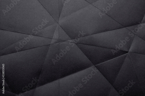 Black crumpled paper texture as background. Copy space text