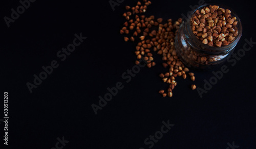 groats, buckwheat on a dark background