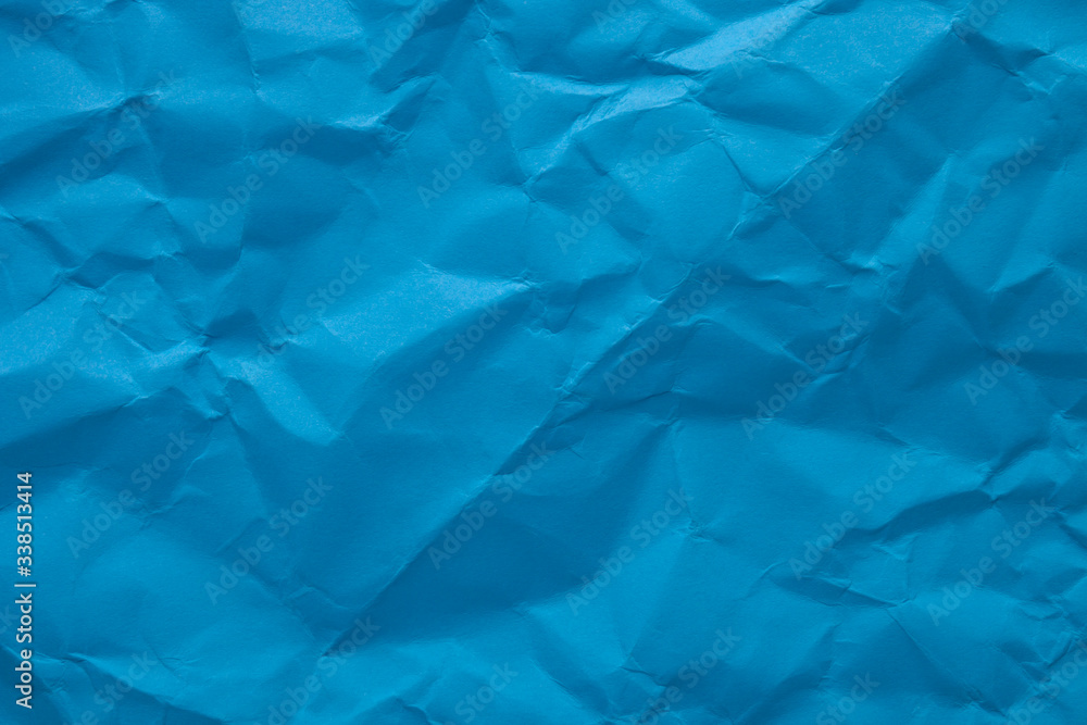 Obraz premium Blue crumpled paper texture as background. Copy space text