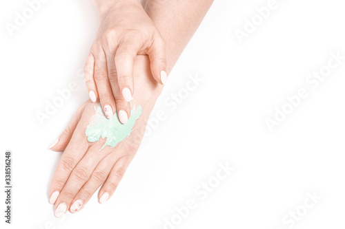 View from above woman's hands apply homemade skin care mask.