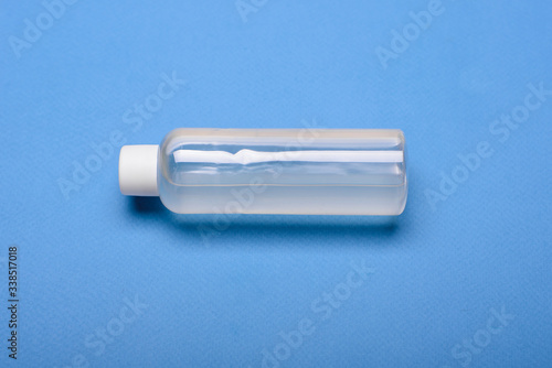 Bottle of antiseptic hand gel isolated on blue