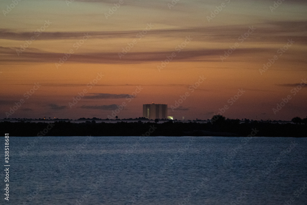 sunrise over lake, launch pad in background, cape canaveral