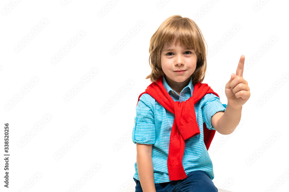 Sports teenager boy in t-shirt with hoody around his neck gesticulates isolated on blue background Sports teenager boy in t-shirt with hoody around his neck gesticulates isolated on blue background