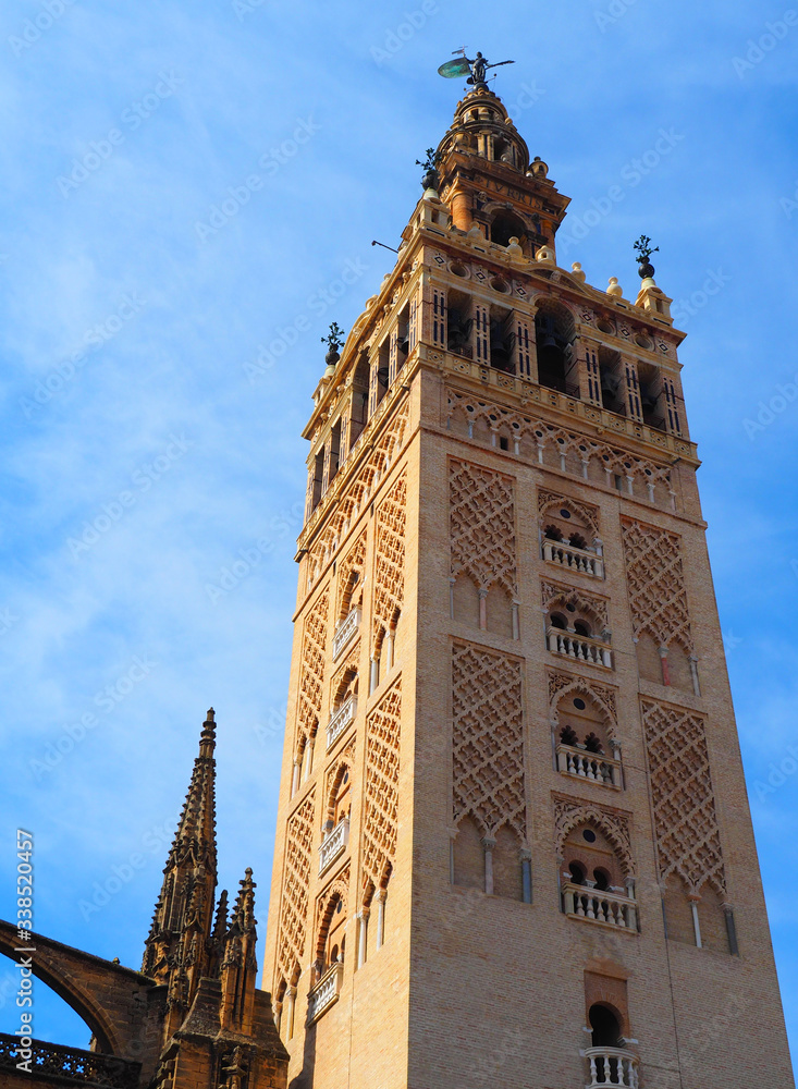 View of the Giralda in Seville, Spain. It is the bell tower of the Cathedral of Saint Mary of the See in Seville, Andalusia, Spain.