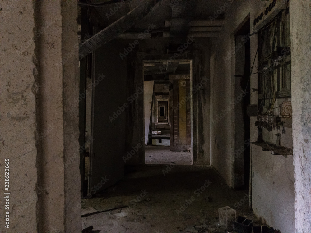 A dark and decaying corridor in an abandoned building