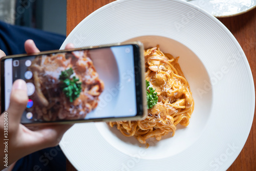  taking photo of  pasta  with smartphone to share on social media