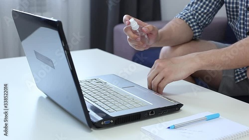 Wallpaper Mural Hands of man cleaning hands with sanitizer gel in front of laptop at home. Work from home due Coronavirus or Covid19 quarantine. Male uses hand sanitizer to protect from coronavirus and virus spread  Torontodigital.ca