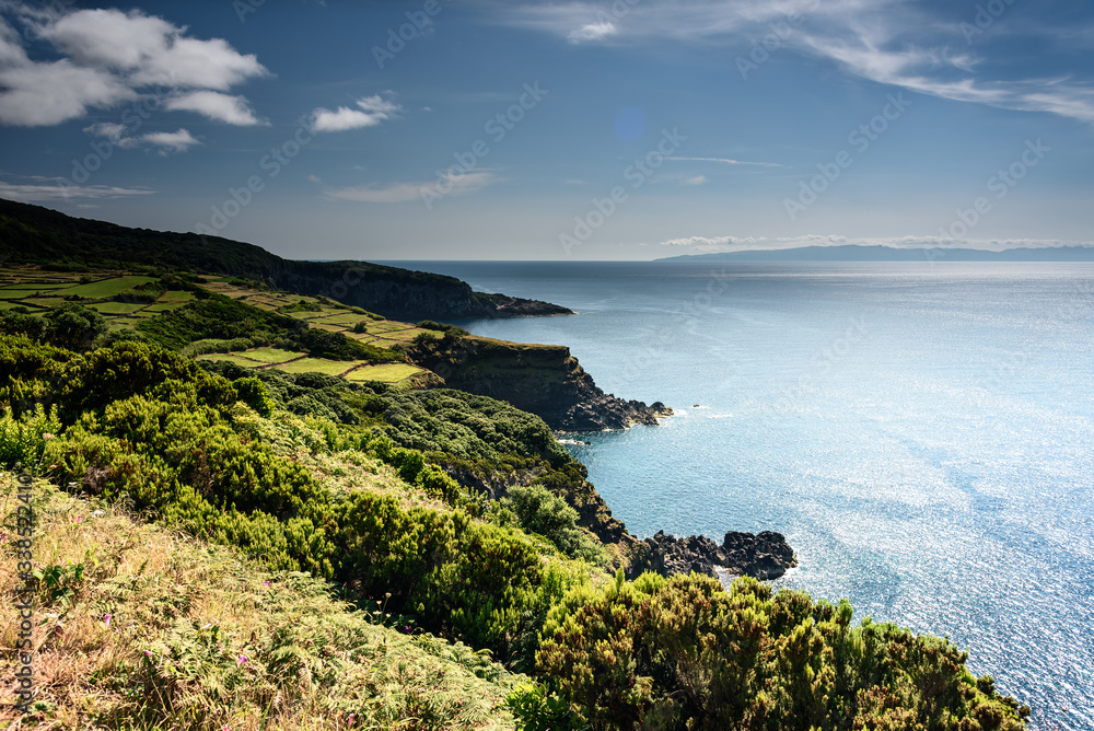 coastline and cliff in terceira.
panorama of the coast and cliff in azores islands during sunset. portugal