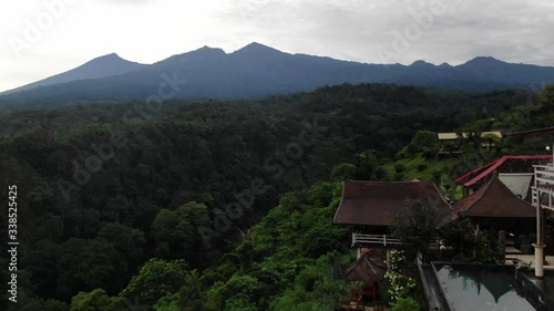 Wallpaper Mural Ascending aerial shot at a luxury resort complex in the middle of rain forest in Asia, mountain scenery in the background.  Torontodigital.ca