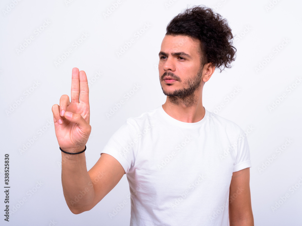 Portrait of handsome bearded Turkish man touching something Portrait of handsome bearded Turkish man touching something