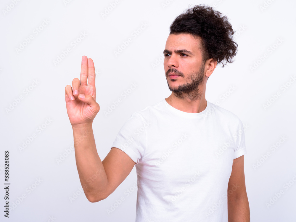 Portrait of handsome bearded Turkish man touching something Portrait of handsome bearded Turkish man touching something