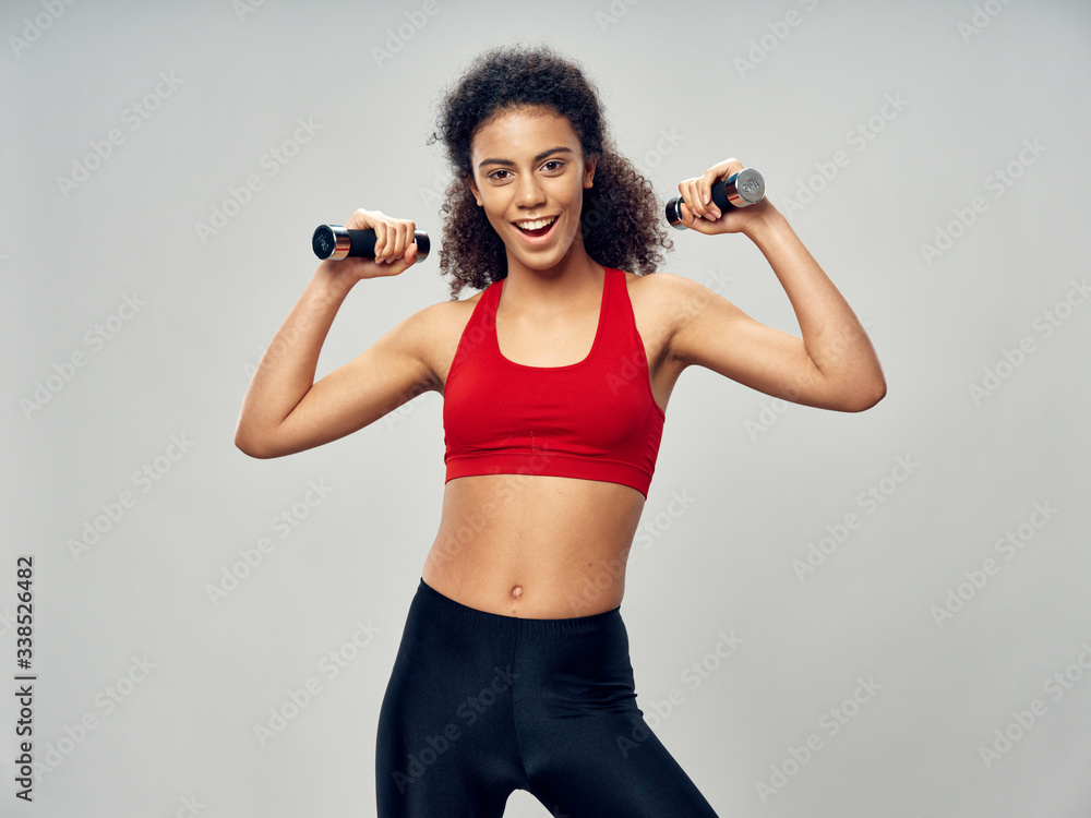 young woman exercising with dumbbells young woman exercising with dumbbells