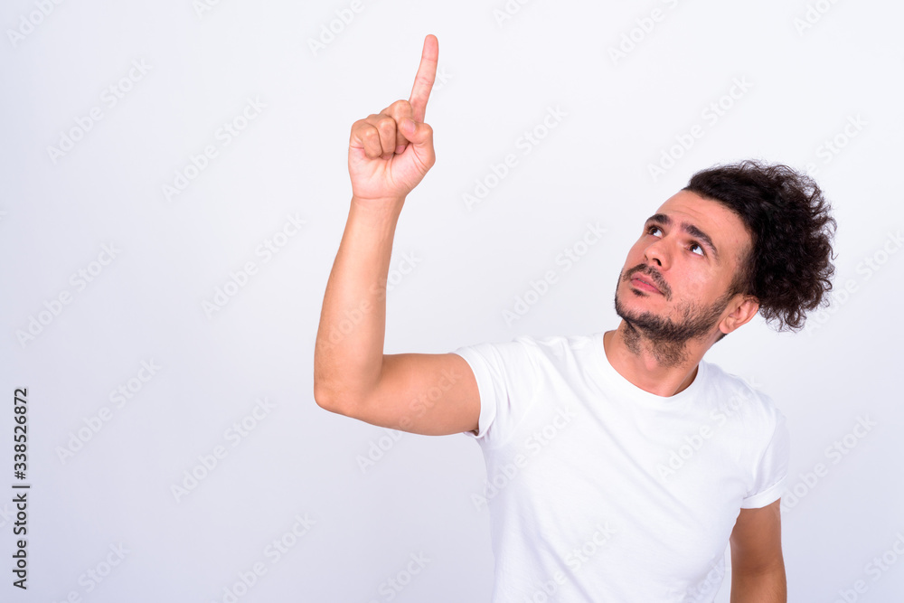 Portrait of handsome bearded Turkish man pointing up Portrait of handsome bearded Turkish man pointing up