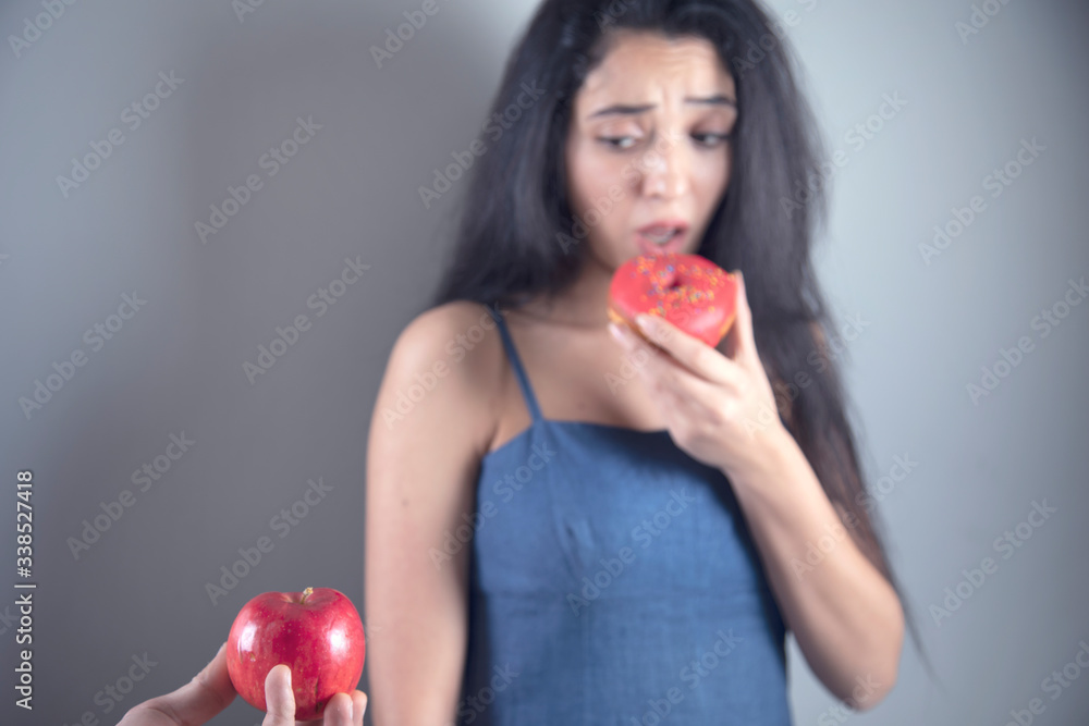 woman hand holding Donut and apple woman hand holding Donut and apple