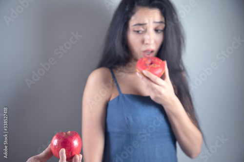 woman hand holding Donut and apple
