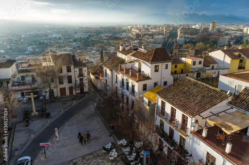 Granada, Spain - February 11th, 2019 :  Overview of the San Miguel Bajo square at the Unesco listed Albayzin district with modern city in background.