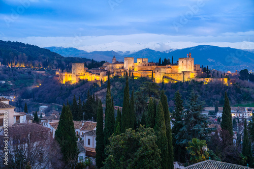 Granada, Spain - February 11th, 2019 :  Illuminated Alhambra palace at dusk.