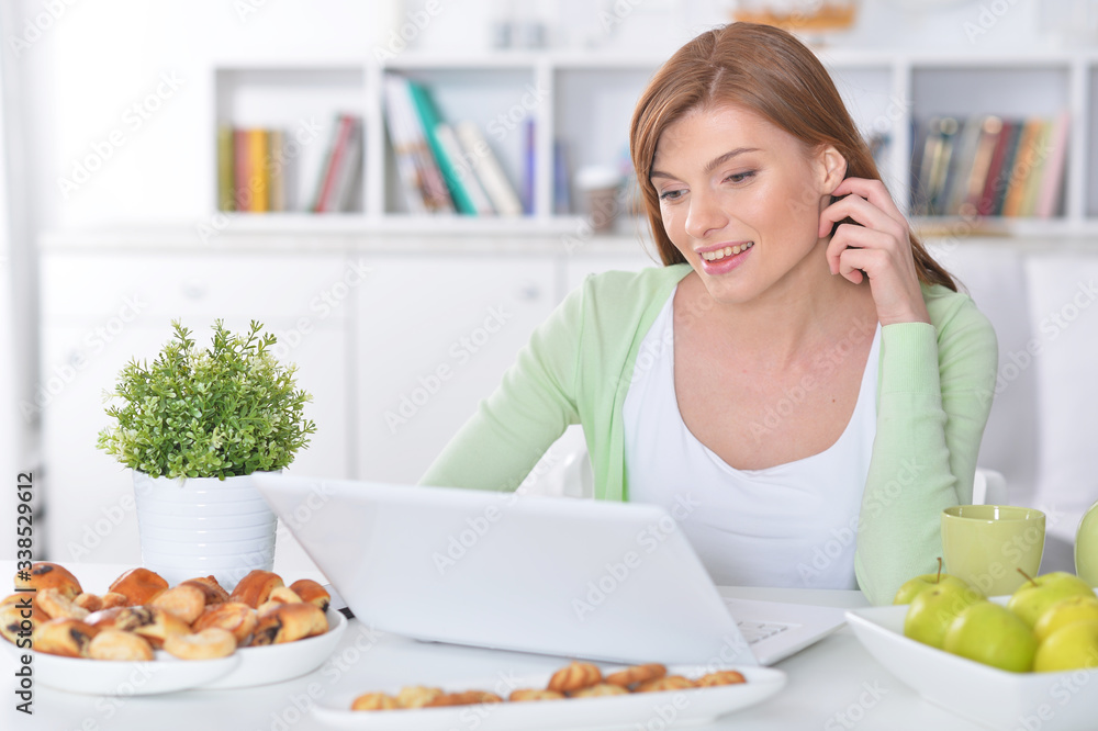 Portrait of beautiful young woman using laptop