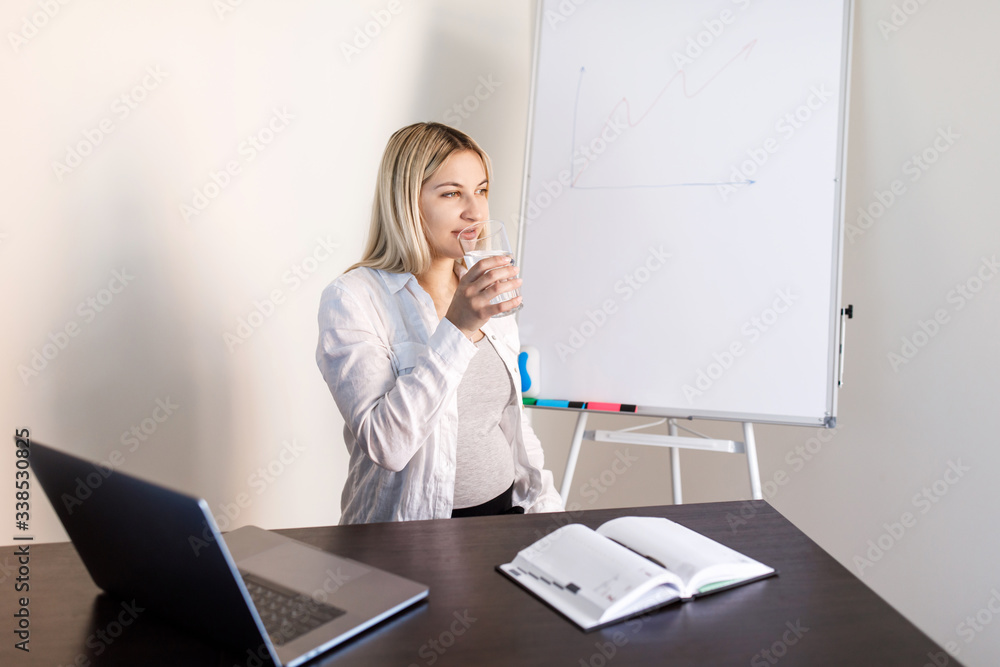 Young pretty pregnant woman is having a lesson in the room. Distance Learning. Pregnant woman running Young pretty pregnant woman is having a lesson in the room. Distance Learning. Pregnant woman running