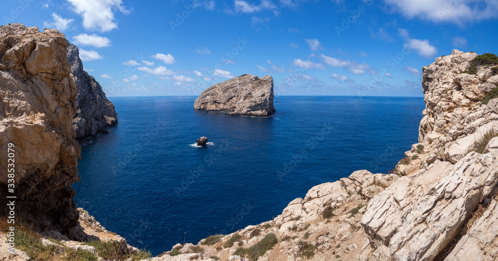 Views of the coast of Sardinia with a big rock in the sea