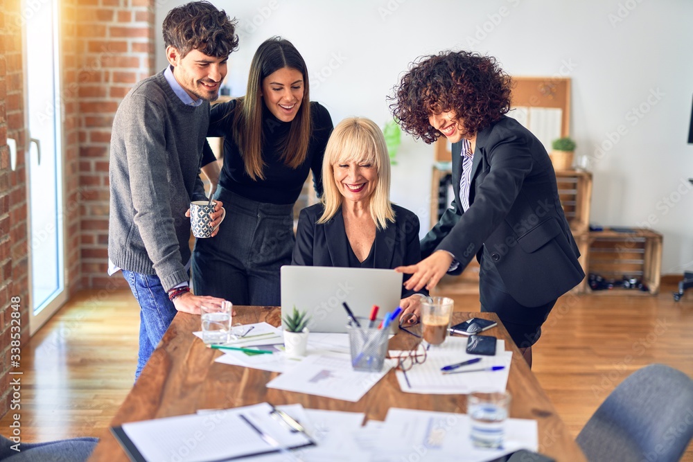 Group of business workers smiling happy and confident. Working together with smile on face using laptop at the office Group of business workers smiling happy and confident. Working together with smile on face using laptop at the office