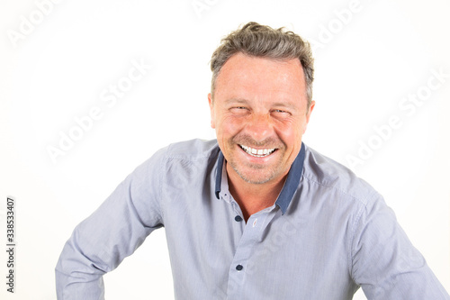 Middle age handsome man wearing blue shirt smiling laughing over isolated white background