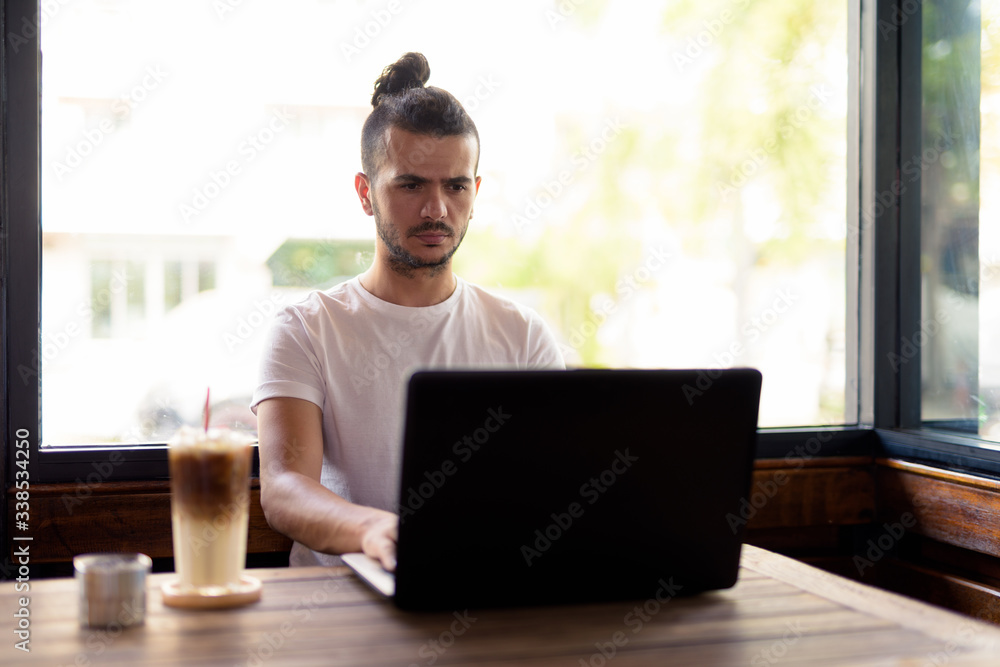 Handsome Turkish man with curly hair relaxing at the coffee shop Handsome Turkish man with curly hair relaxing at the coffee shop