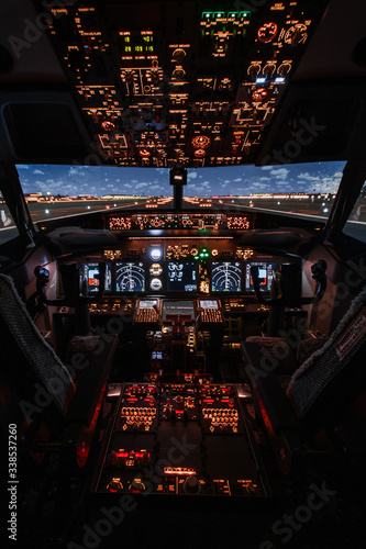 Dramatic Full view of cockpit modern Boeing aircraft before take-off. Airplane is ready to fly. Night shot in cabin. Safety flight