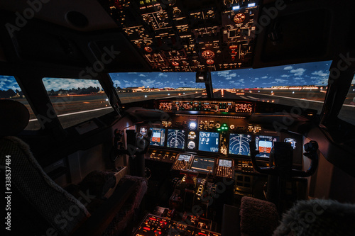 Dramatic Full view of cockpit modern Boeing aircraft before take-off. Airplane is ready to fly. Night shot in cabin. Safety flight
