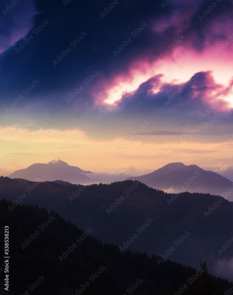 spectacular european summer sunset image, vertical sunrise scenery, foggy hills on background amazing sky, colorful summer evening landscape in the mountains, Carpathians, Europe, Ukraine