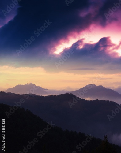 spectacular european summer sunset image  vertical sunrise scenery  foggy hills on background amazing sky  colorful summer evening landscape in the mountains  Carpathians  Europe  Ukraine