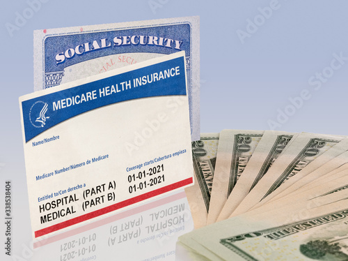 USA social security card and a Medicare health insurance card with 20 dollar paper currency to show funding crisis photo